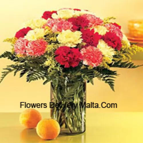 25 Mixed Colored Carnations With Seasonal Fillers In A Glass Vase