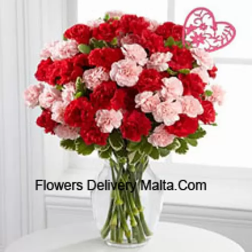 37 Carnations ( 19 Red And 18 Pink ) With Seasonal Fillers And Heart Stick In A Glass Vase