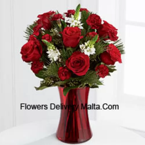 This romantic arrangement bristles with the passion and wonder of the Christmas season. Rich red roses and burgundy mini carnations accented with the snowy white blooms of Stars of Bethlehem, pine branches, and lush greens will easily sweep them off their feet. Arranged in a ruby red clear glass vase, this bouquet conveys your most heartfelt holiday wishes. (Please Note That We Reserve The Right To Substitute Any Product With A Suitable Product Of Equal Value In Case Of Non-Availability Of A Certain Product)